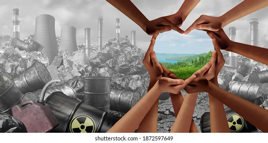 Most of the picture is black and white, tall smokestacks, barrels of toxic waste, dirty air. Many hands and forearms of all different skin colours form the shape of a heart. The heart's center is green grass and blue sky looking very beautiful.